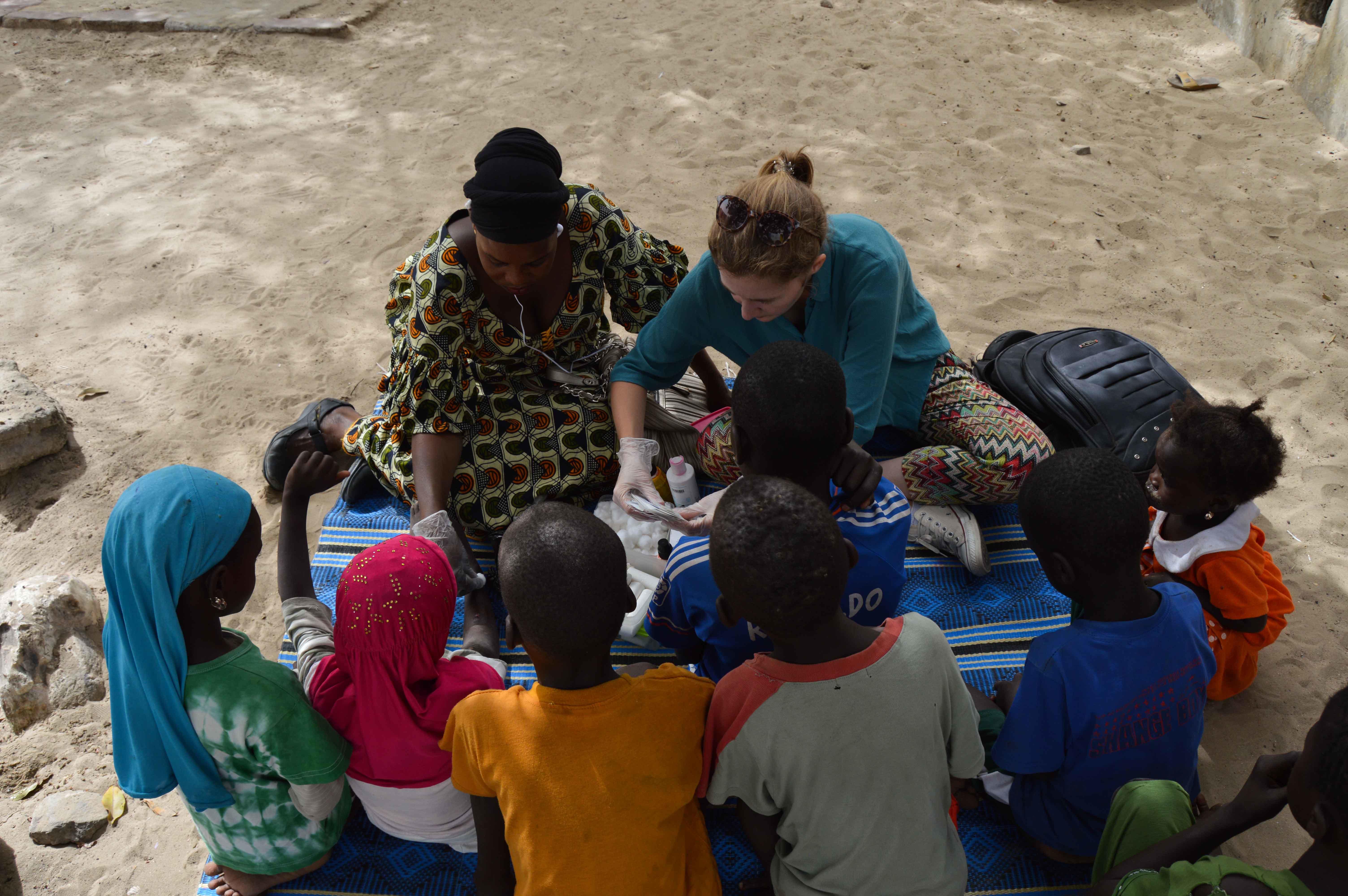 A Projects Abroad volunteer provides medical care for her volunteer work with children in Senegal. A volunteer with children in Senegal provides medical care during an outreach.